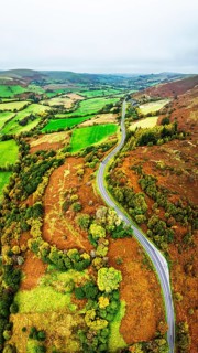 Autumn colours of Farms over River Wye and Road A470 from a drone, Llanidloes, Powys,