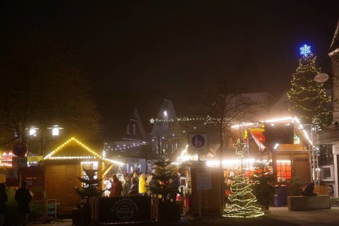 A bright Christmas market at night with colorful lights and lively decoration, Winterberg, North