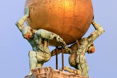 Two atlases carry a gilded globe with Fortuna carrying a moving wind vane, Venice, Veneto, Italy