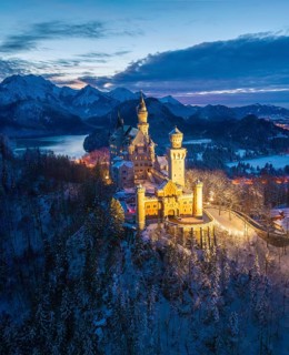 Illuminated Neuschwanstein Castle in winter in evening mood, night view, Schwangau near Füssen,