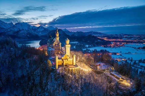 Neuschwanstein Castle illuminated in snowy night landscape, night view, Schwangau near Füssen,