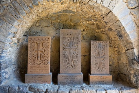Three khachkars with detailed stone carving in a stone niche, cross stones, Akhtala monastery,
