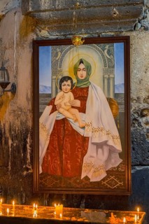 Madonna icon with child in a candle-illuminating church room, Akhtala monastery, Akhtala town,