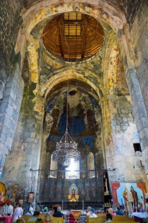 Large church interior with old wall paintings and a richly decorated altar, Akhtala monastery,
