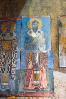 Icon painting on an old stone church wall depicting holy figures, Akhtala monastery, Akhtala, town
