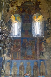 Historical wall paintings under windows in a bright church interior, Akhtala monastery, Akhtala