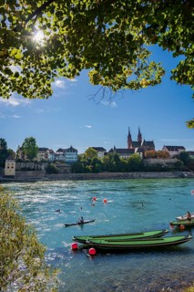 The Rhine with rowing boats in the sunshine in the late afternoon, Basel