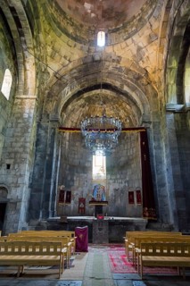 Spacious church room with altar, high ceiling and magnificent chandelier, Sanahin monastery,