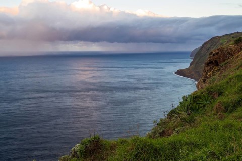 Sunset, rainbow over sea, at Farol da Ponta do Pargo lighthouse, west coast, Madeira, Portugal