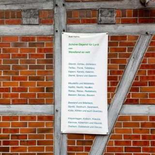List of various villages in Wendland, poem, banner on a half-timbered wall, façade detail,