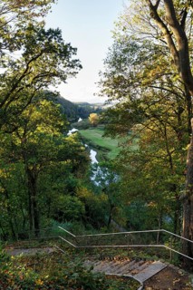 View from a viewpoint with stairs of picturesque river landscape, forest and meadows, Jeetzel,