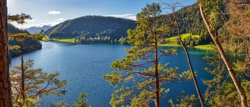 Clear blue lake surrounded by forests and mountains, Austria, Hintersteinersee, panorama