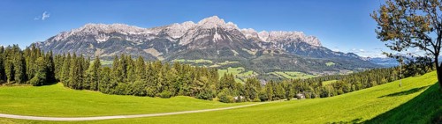 Wide green meadows against an impressive mountain backdrop, Austria, Ellmau, panorama