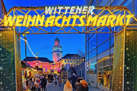 The entrance to the Witten Christmas market with the illuminated town hall, Ruhr area, North