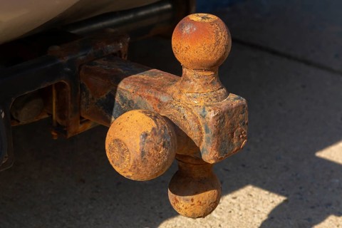 Close-up of rusted tri-ball trailer hitch attached to sport utility vehicle, Quebec, Canada