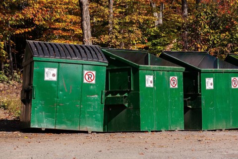 Green painted metal with black plastic lid industrial size waste bins for depositing garbage and
