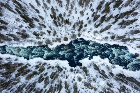 Aerial view over rapids in the river Kitkajoki in winter, Oulanka National Park, Northern