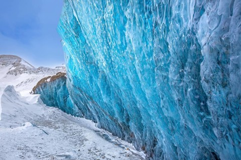 Glacier wall showing smooth melting blue ice made of compressed snow, Spitsbergen / Svalbard,