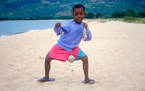 Little boy posing with caught fish for camera, Chitimba, Lake Malawi, Africa, July 2000, vintage,
