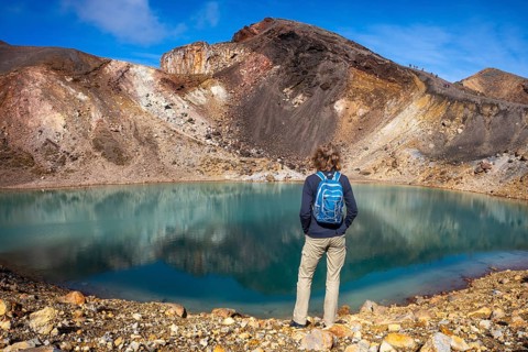 A hiker at one of the Emerald Lakes and Red Crater, Panorama, Tongariro alpine crossing, Tongariro