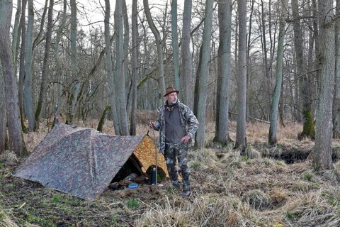 Camp of a nature photographer, nature photographer in front of his camouflage camp in the