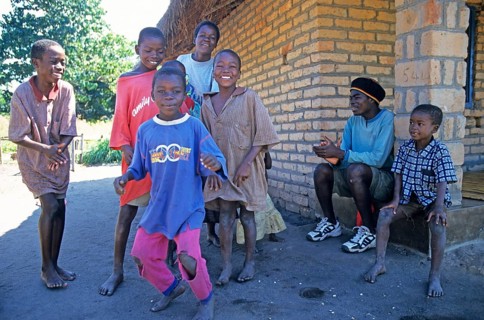 Local children dance happily to music in a village near Kande, Lake Malawi, Malawi, Africa, July