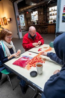 Detroit, Michigan - Volunteers with the Detroit Peoples Assembly put together whistle kits. The