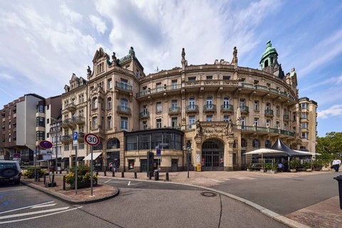 Historic building, former hotel palace hotel, barrier bollard, street, round façade with windows,