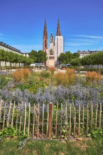Park, flower bed, plants, wooden fence, Waterloo monument, St. Boniface Catholic Church,