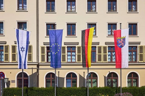Flags, Israeli flag, European flag, German flag, flag of Hesse, flagpoles, façade with windows and