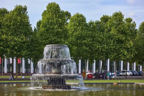 Cascade fountain, lawn, trees, general buildings, pedestrians as accessories, frozen movement,