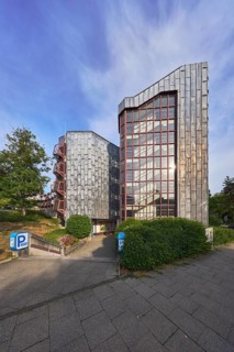 Theatre car park, modern architecture, entrance, access, sidewalk, trees, bushes, lawn, blue sky,