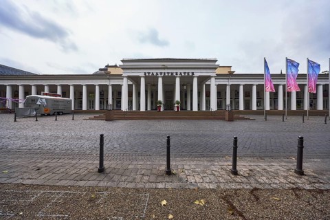 Hessian State Theatre, theatre crowds, brick street, barrier bollard, advertising flag on