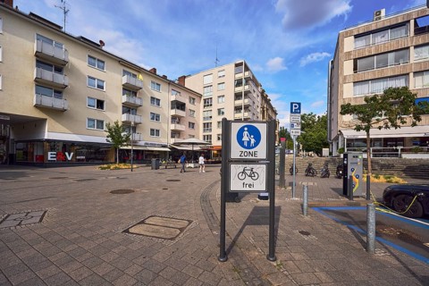 Pedestrian zone road sign, additional sign for cyclists free, general architecture, houses,