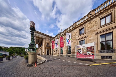 Spa hotel, access road, brick street, entrance area, flags on flagpoles, neoclassical style with