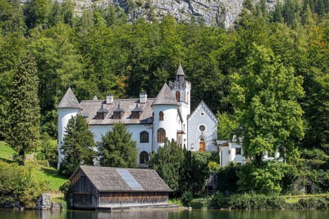A, Hallstatt, An idyllic lakeside castle surrounded by a thick green forest, Austria
