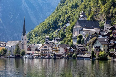 A, Hallstatt, An idyllic village with a lakeside church, surrounded by wooded mountains, Austria