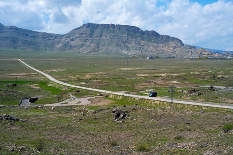 Panoramic view of a rural road winding through a vast mountain landscape, landscape near Demirtepe,