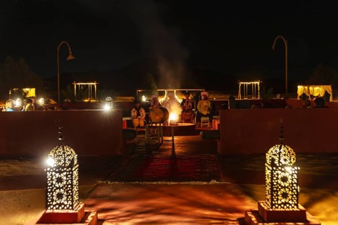 Evening meeting with lanterns and fireplace, cozy atmosphere, Sahara, Morocco