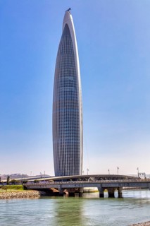 Modern skyscraper on a river with a bridge under clear sky, Mohammed VI Tower in Rabat in Morocco