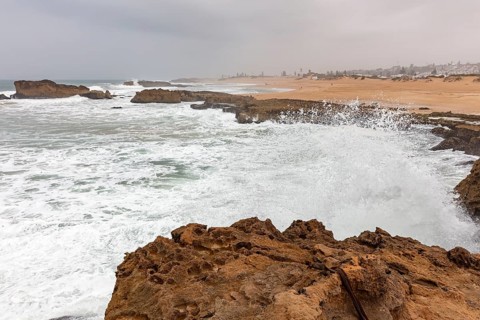 Ocean surf against rocks on a stormy coastline