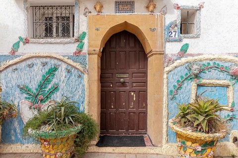 Traditionally decorated house entrance with plants and floral patterns