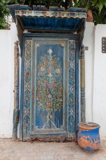 Elaborately decorated blue door with oriental patterns, the oldest door in the Kasbah of Oudaia in