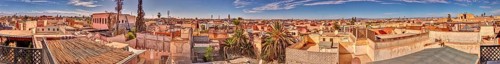 Panoramic view over rooftops of a historic city with blue skies