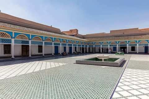 Spacious courtyard with central fountain and colorful arcades in the shadow of the sky, Bahia