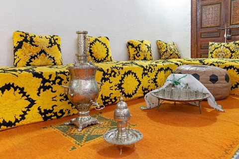 Inviting Moroccan sitting area with elaborate tea set on a decorative tray, Bahia Palace in