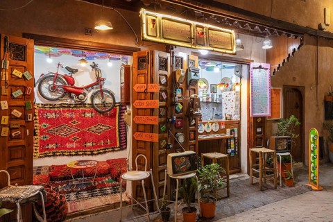 Colourful cafe with decoration and lights, a wheel hanging on the wall