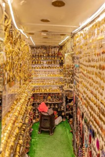Tight shop full of shiny golden decorations and traditional goods