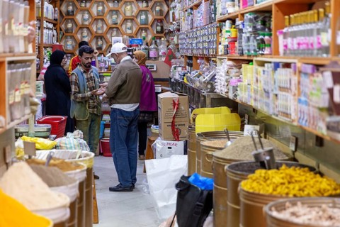 Colourful spice shop with people talking and looking at different products