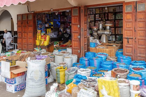 Open shop full of bags and products, traditional product presentation with wooden doors